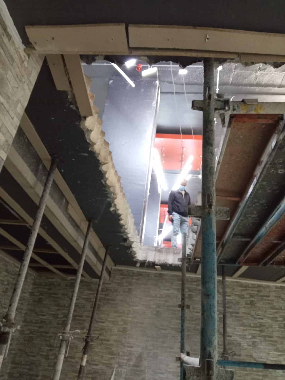 View from below of a completed stitch core drill opening through a 250mm solid concrete slab — lift shaft installation, Central Johannesburg