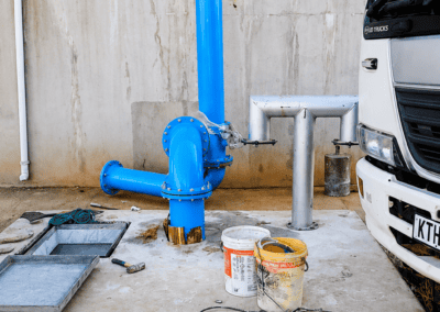 Blue pipework and concrete core drilling equipment at the Moloto reservoir project