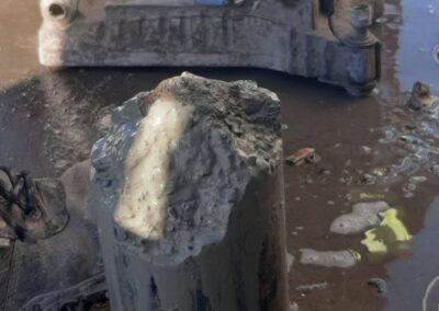 Vus Core Drilling performing core drilling on concrete with specialized equipment.